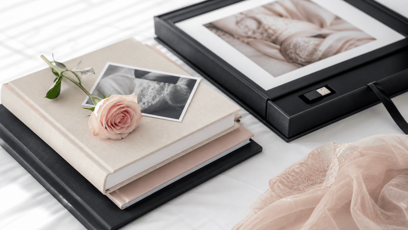 Soft-lit bedroom scene with lingerie and a price list on a clipboard beside blush roses on white sheets